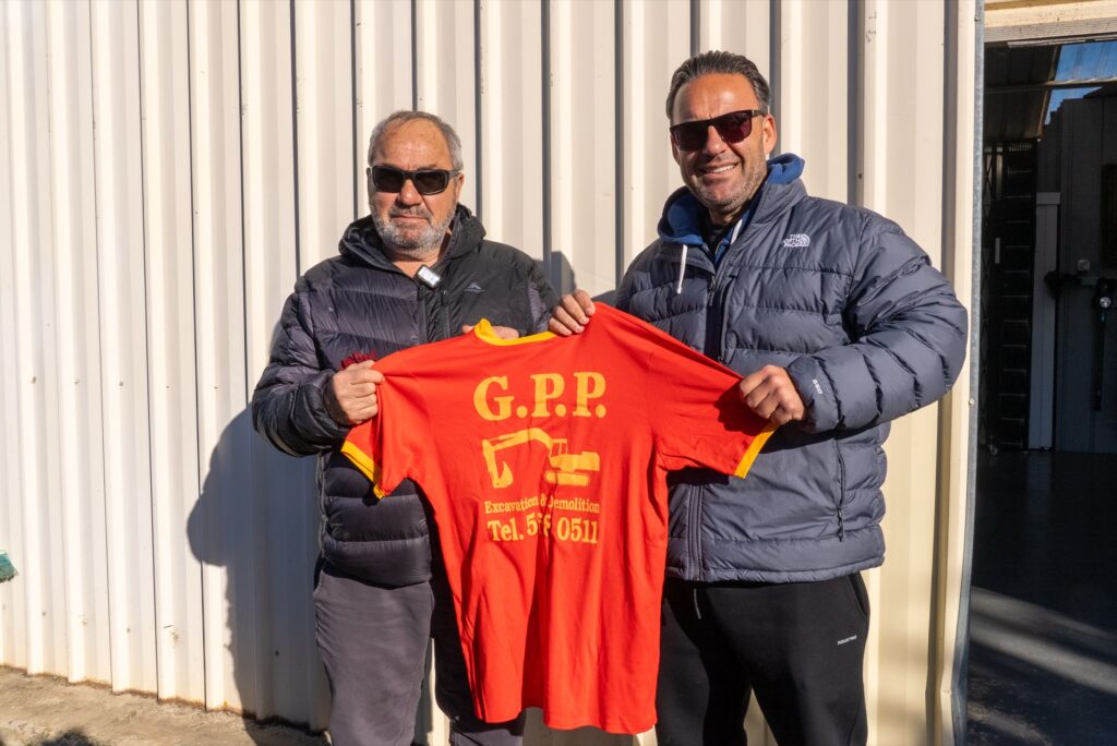 Two generations of G.P.P. holding an original G.P.P. company shirt